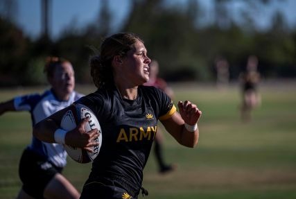 Army 1st Lt. Naomi Colin sprints past Air Force Master Sgt. Sahtara Wehe during Army's 15-14 triumph in the 2025 Armed Forces Women's Rugby Championship game Sept. 7 in Chula Vista, Ca. (Dept. of War Photo by PO1 Colby Mothershead, released)